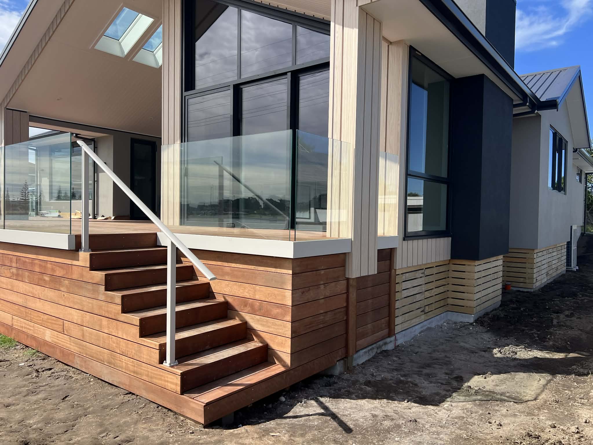 Modern home exterior with deck and glass balustrade